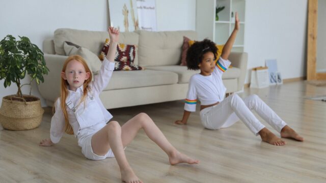adorable diverse girls training together on floor