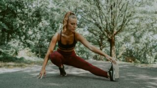 flexible sportswoman doing lunges forward exercise